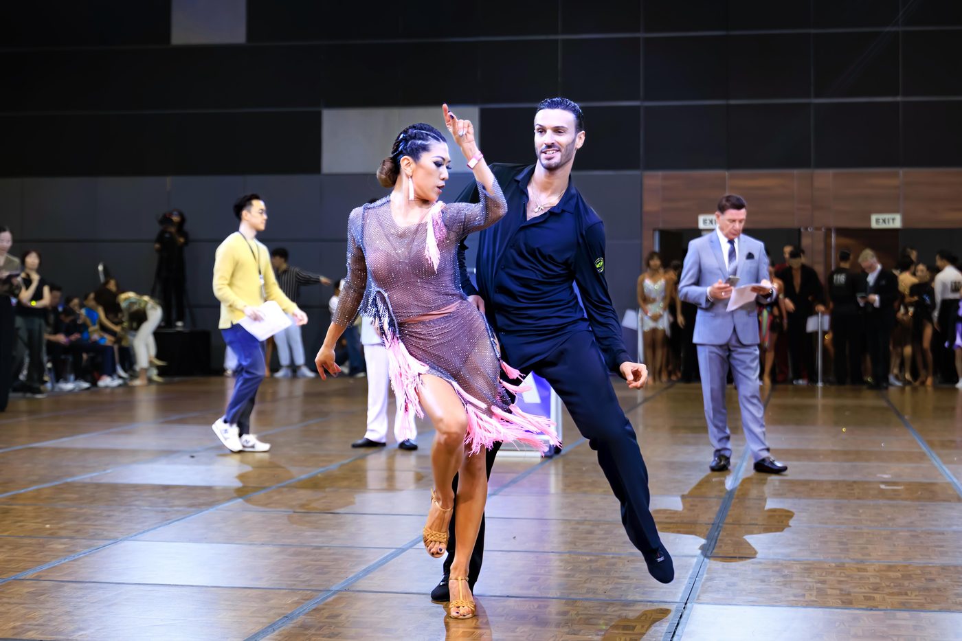 Raliza Velichkova dancing with a partner on a busy competition floor